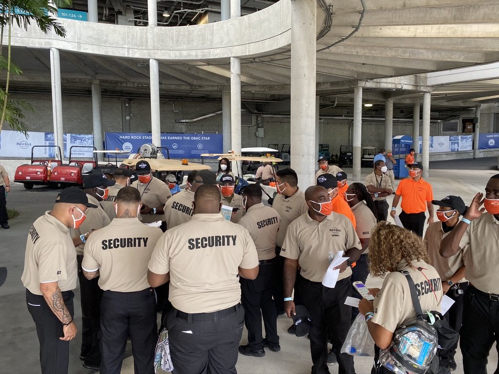 Security Alliance uniformed officers at a pre-shift briefing for large-venue stadium event operations