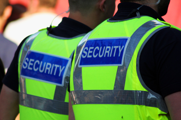 Two Security Officers Wearing Vests