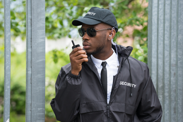 Uniformed Security Officer on Communication Device